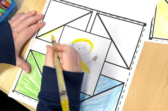 A kindergarten student completes a class quite square for all about me activities